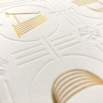 Close up on the beveled printed design on white card showing texture
