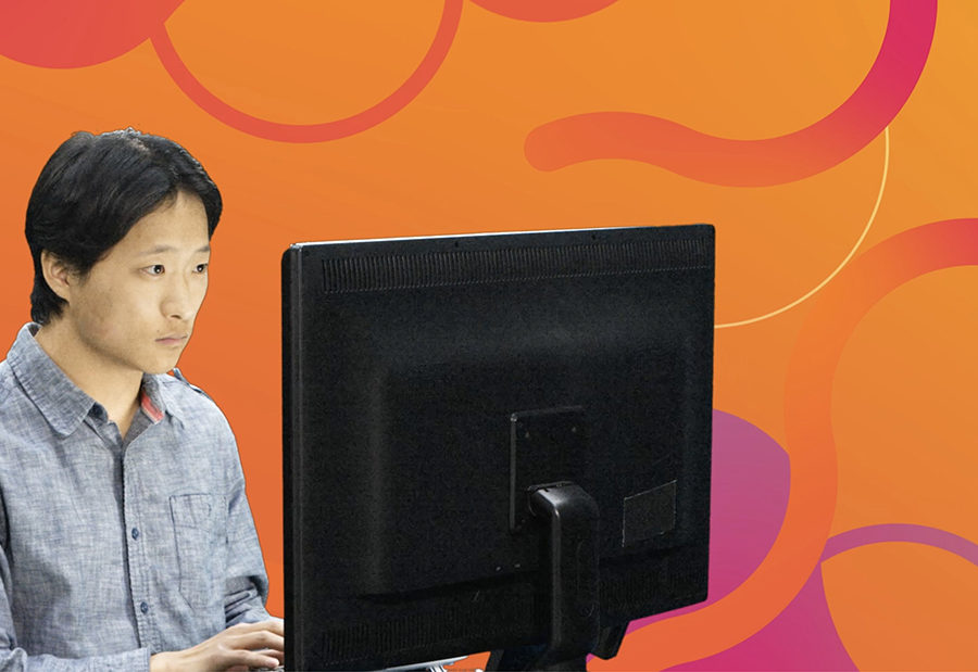 Man working on desktop computer with abstract vector designed orange and purple background